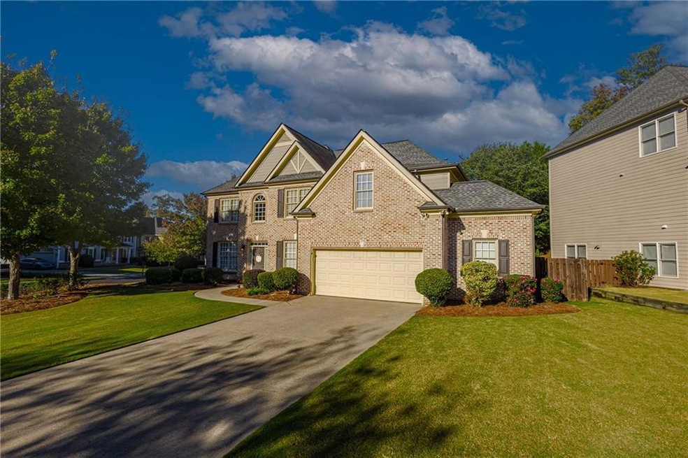 Traditional-style house with brick siding, concrete driveway, and an attached garage