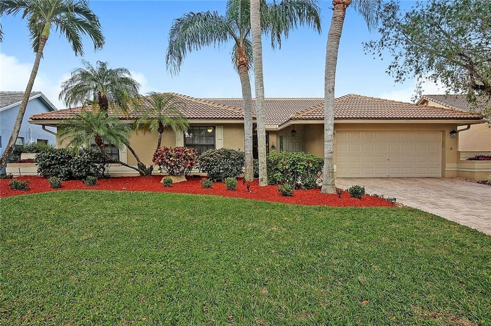 Fresh, clean curb appeal from the pavers to the palms.