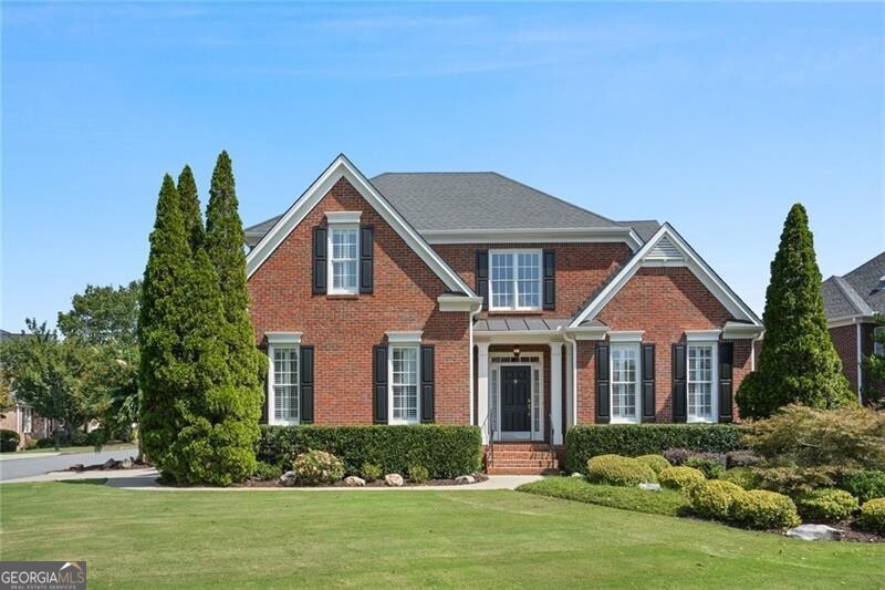 Three sided brick home with master suite on main l