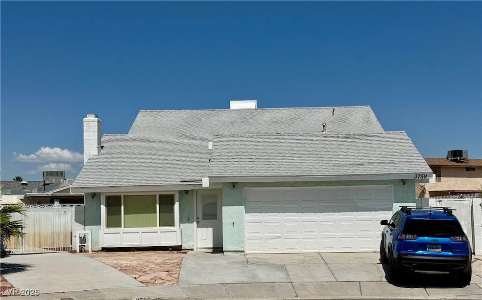 View of front facade featuring a garage, roof with