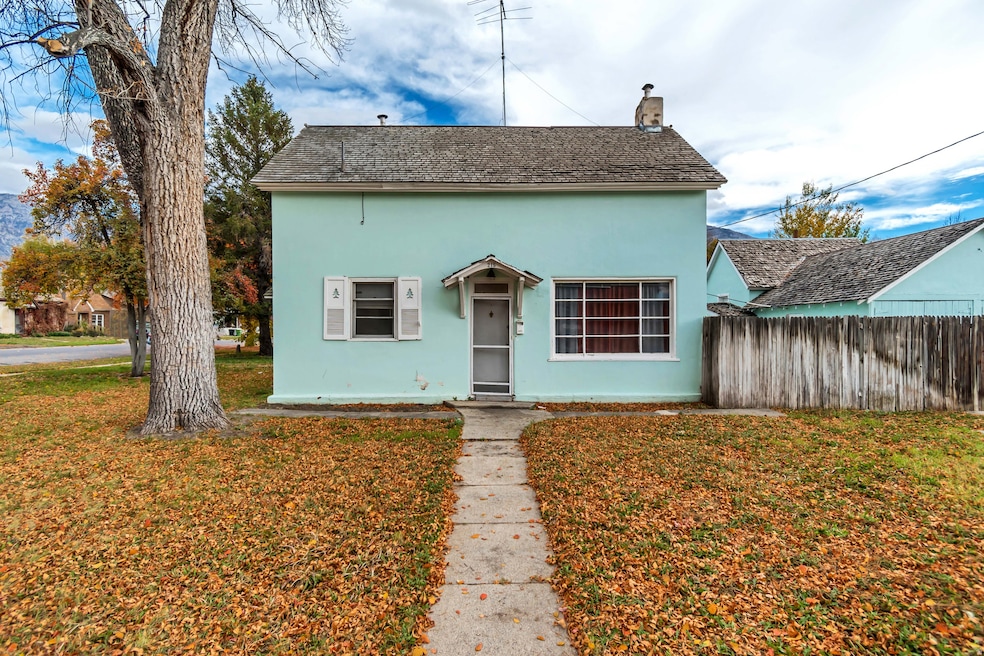 View of front of property featuring a chimney and stucco siding