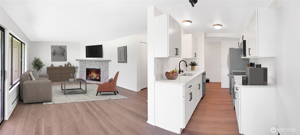 Kitchen and living space with lots of natural light. Featuring brand new blinds and flooring. Cozy up with your wood burning fireplace in this beautiful living space.
