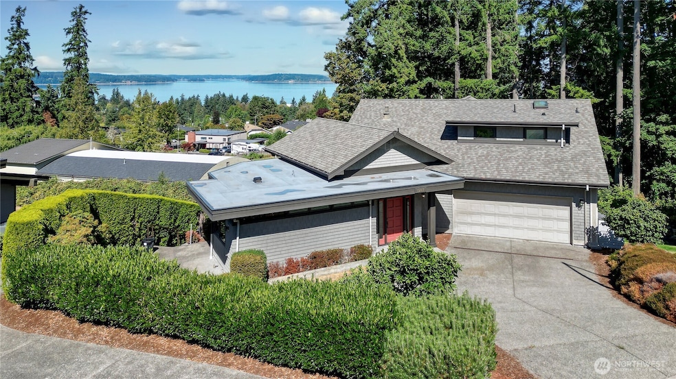Drone view of the front of the property. Located on a quiet cul-de-sac with similar luxury homes around, this contemporary is beautifully original in so many ways. Love the plentiful driveway parking for you and guests.