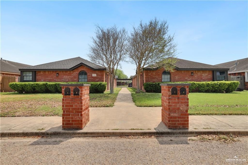 View of front of house with a front yard, brick siding, and a shingled roof