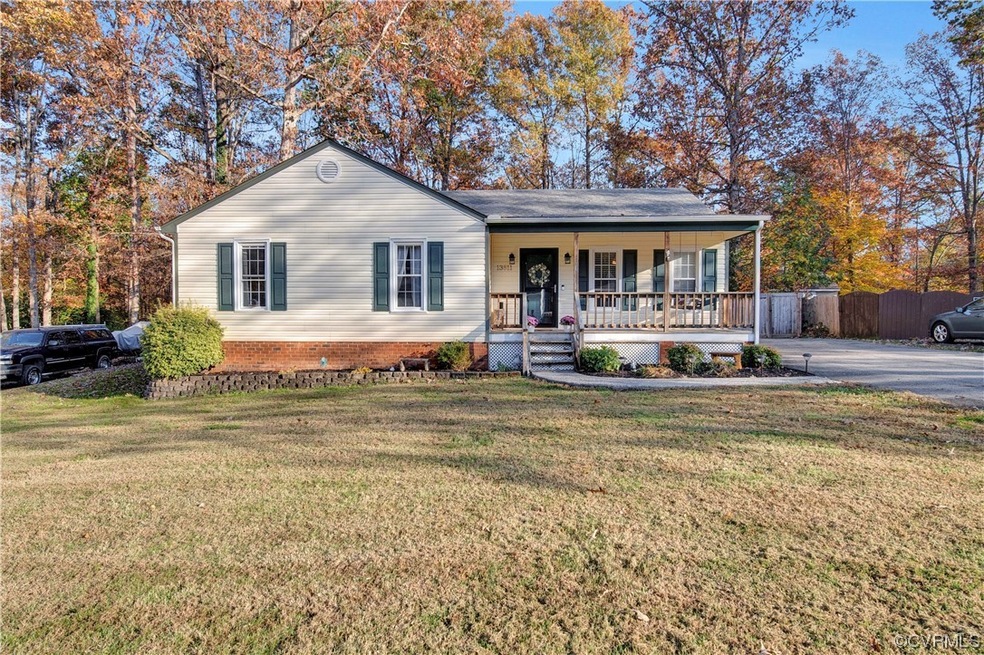 Single story home featuring a front yard and cover