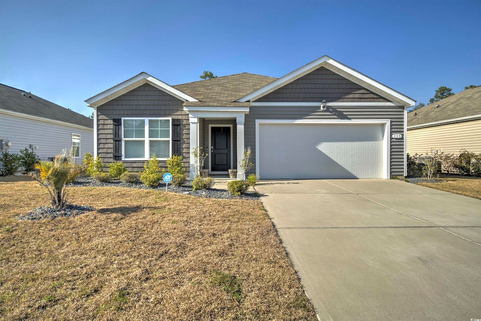 View of front of property with driveway and a garage