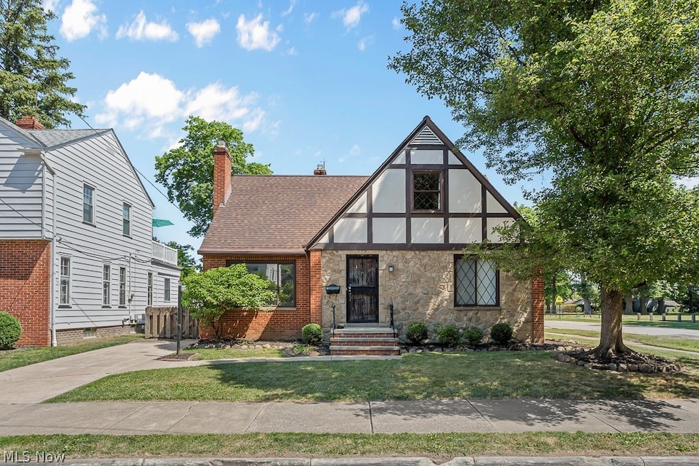Tudor home with a front yard