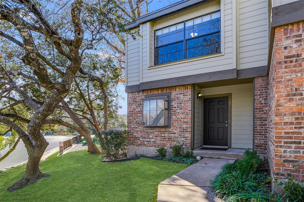 Entrance to property featuring brick siding and a