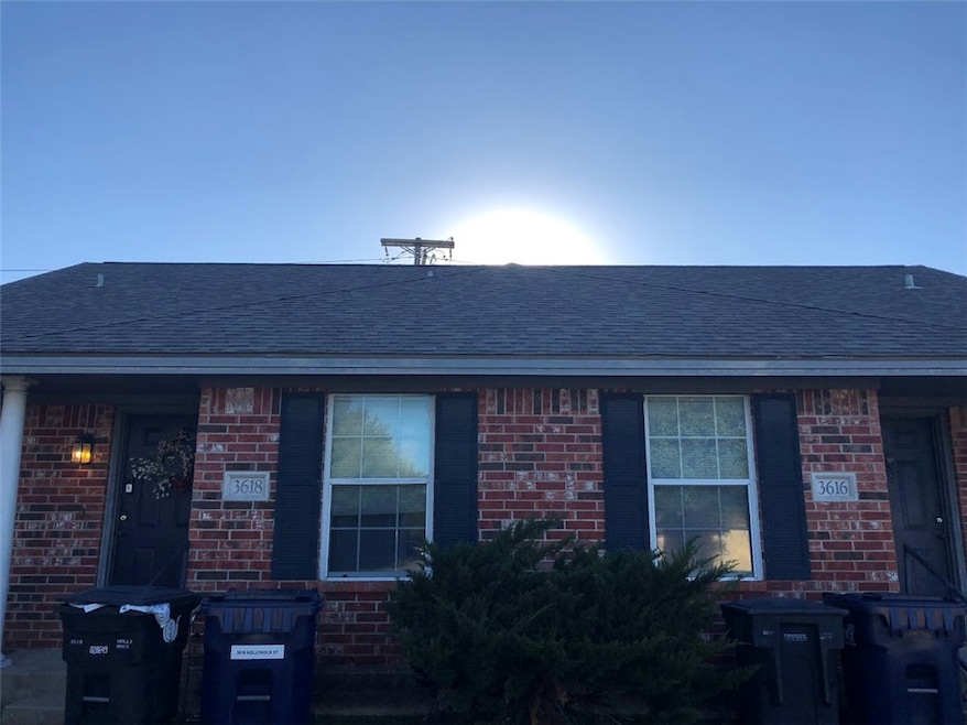 View of front of home with brick siding and roof w