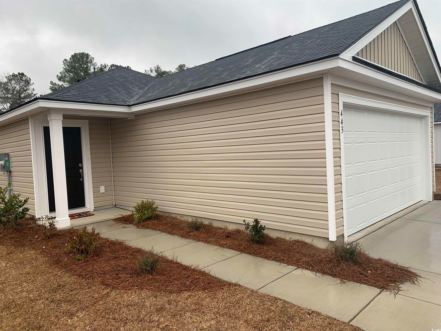 View of side of home featuring a garage, a shingle