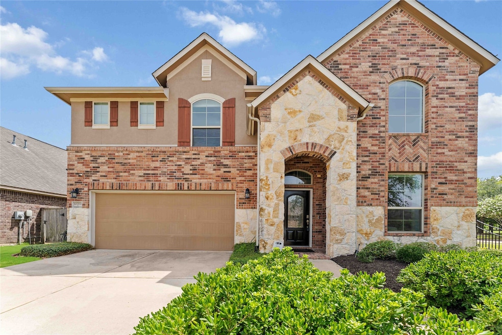 Stunning brick and stone elevation with arched ent