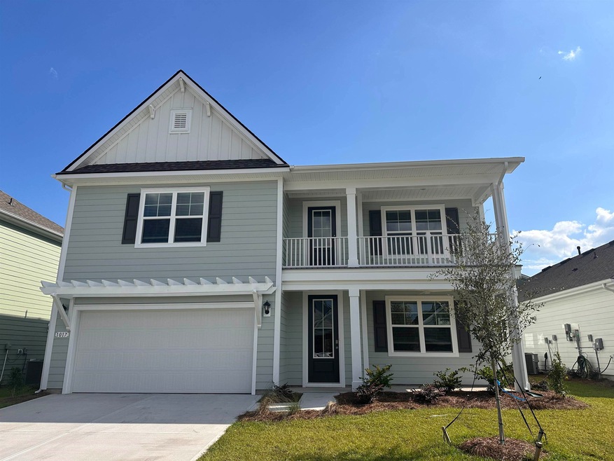 View of property with a balcony, a garage, and a f