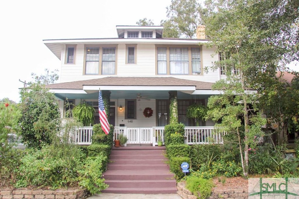Stairs lead up to a gated front porch for added pr