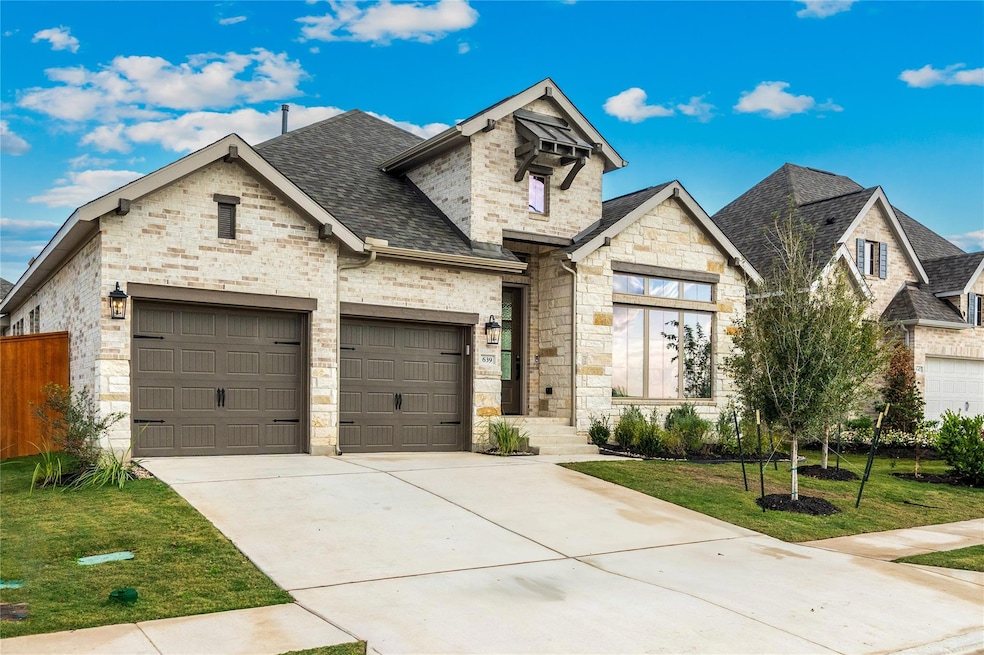 French country home with an attached garage, ston