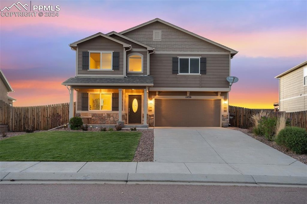 Craftsman house with a garage and a yard