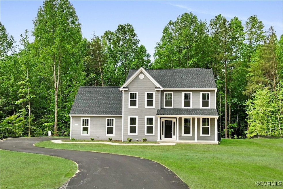 Colonial-style house featuring a front lawn