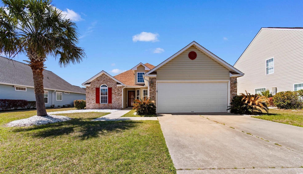 Traditional home with a front lawn, driveway, an a