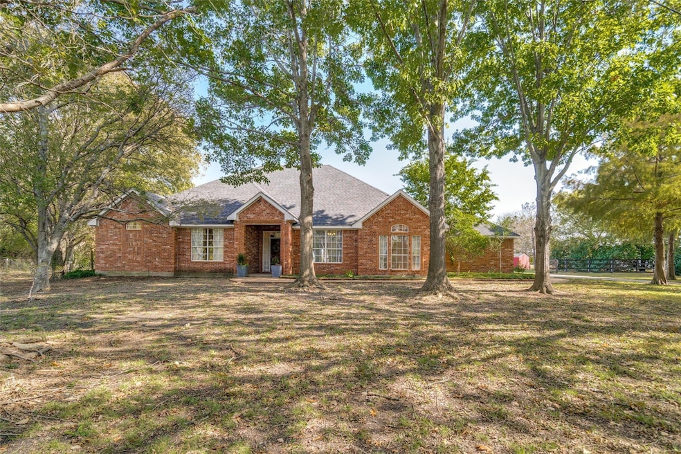 Single story home featuring brick siding, a front 