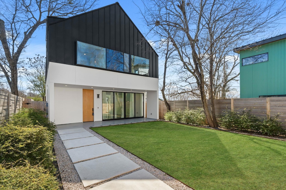 Rear view of house with a fenced backyard, a yard