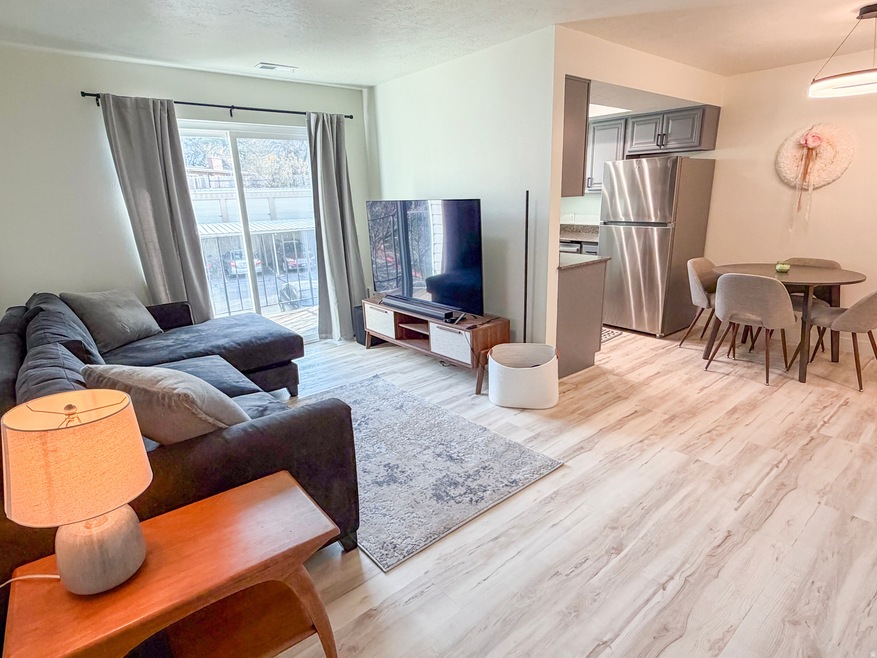 Living area with light wood finished floors and a textured ceiling