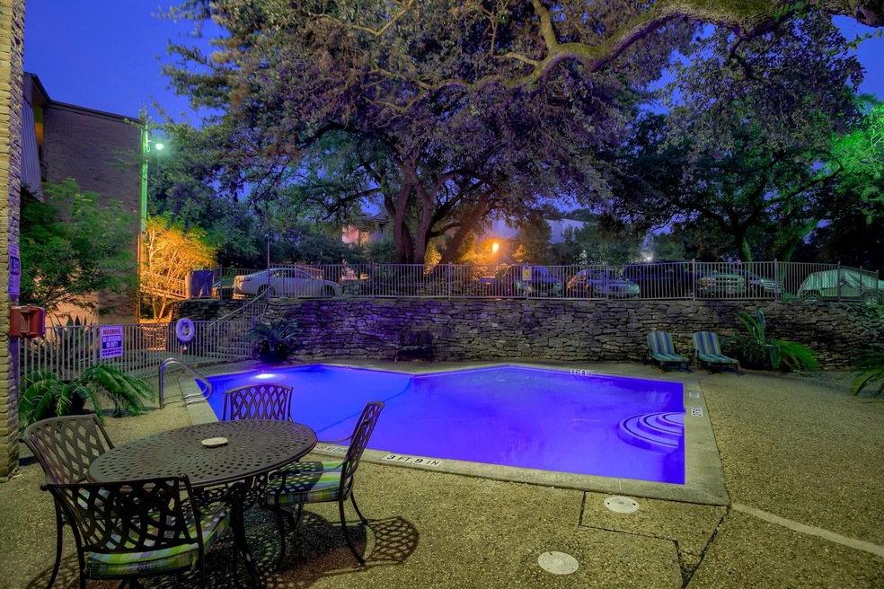 Community pool with fence and a patio area