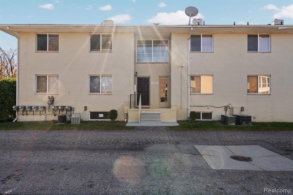 Rear view of property featuring brick siding