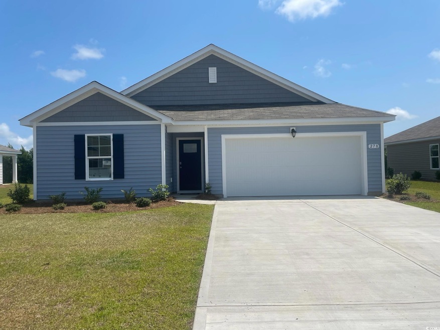 View of front of house with a garage and a front y