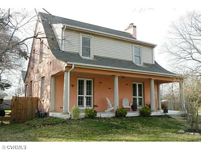 Facade/Exterior Front - Does it get anymore inviting?  The side porch is a great foul weather gathering spot for guests accessed by both the LR and DR!