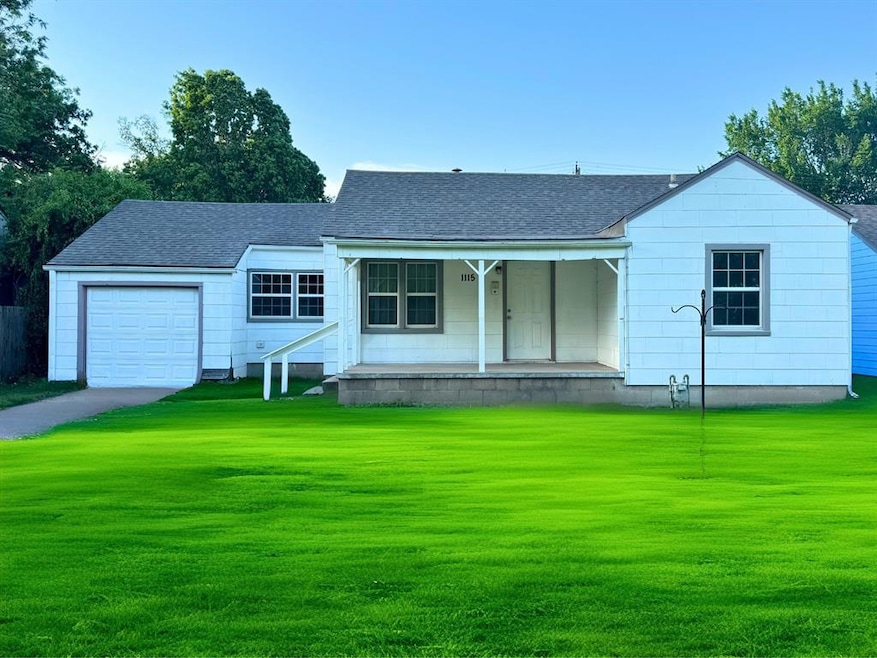 View of front of house , covered porch, garage, and shingled roof.*Grass virtually enhanced
