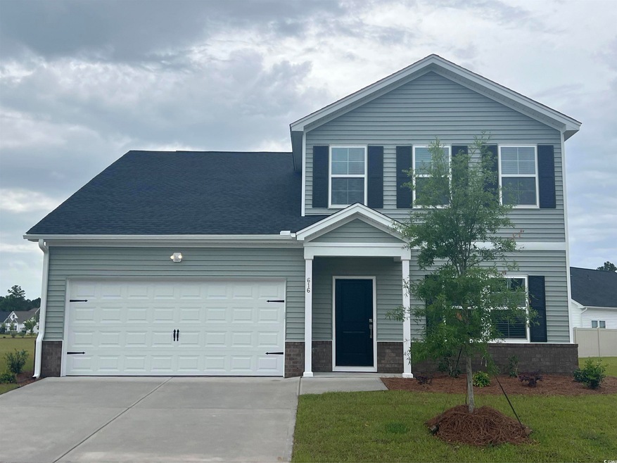 Traditional home with concrete driveway and an attached garage