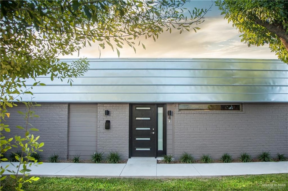 Entrance to property featuring brick siding