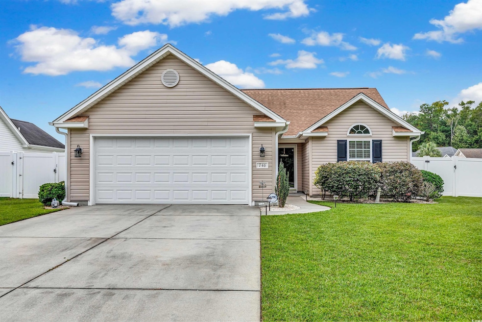 Ranch-style home featuring a front lawn and a gara