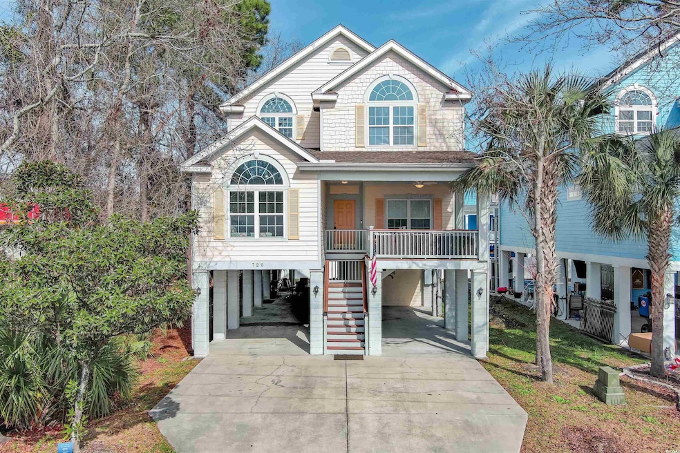 Coastal inspired home featuring a carport and a po