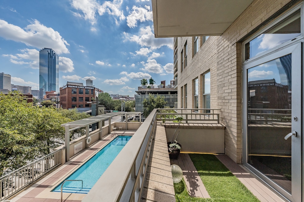 Balcony featuring view of pool area and a view of city