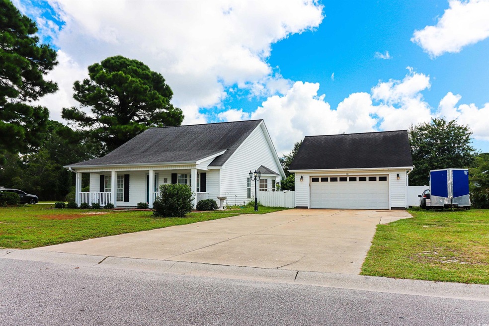 View of front facade featuring a garage, a porch, 
