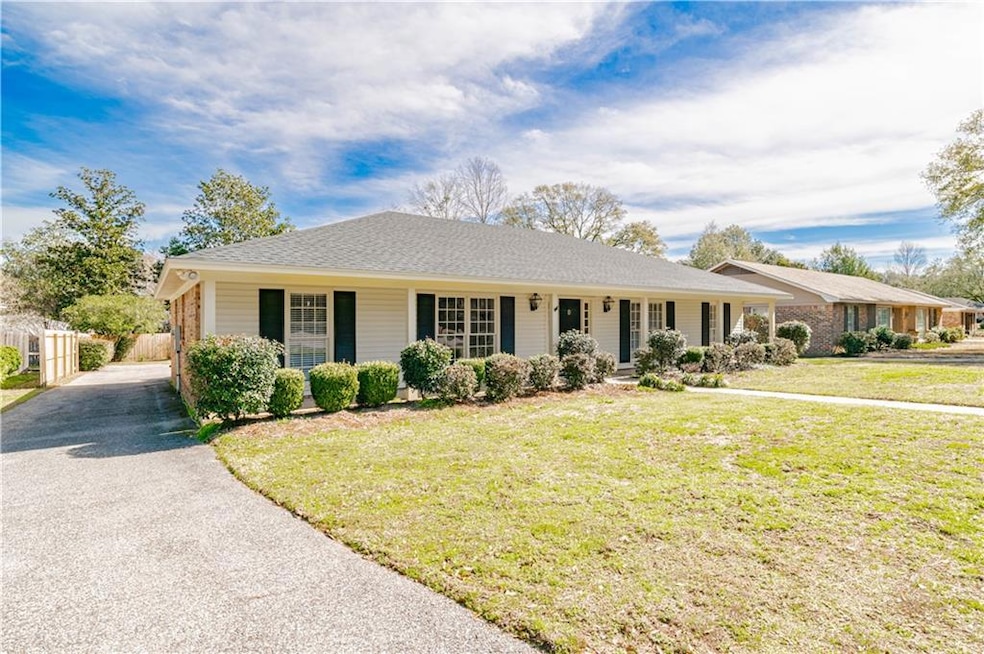 Single story home featuring a front lawn and a por