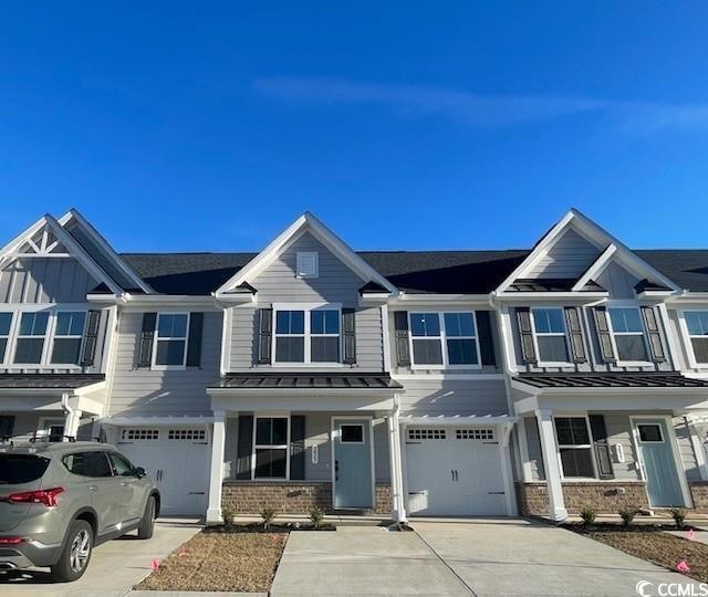 Townhome / multi-family property featuring a garag