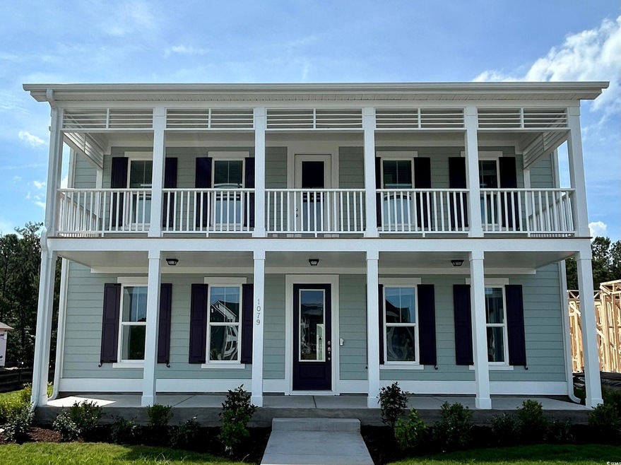 View of front of home featuring a balcony and a porch