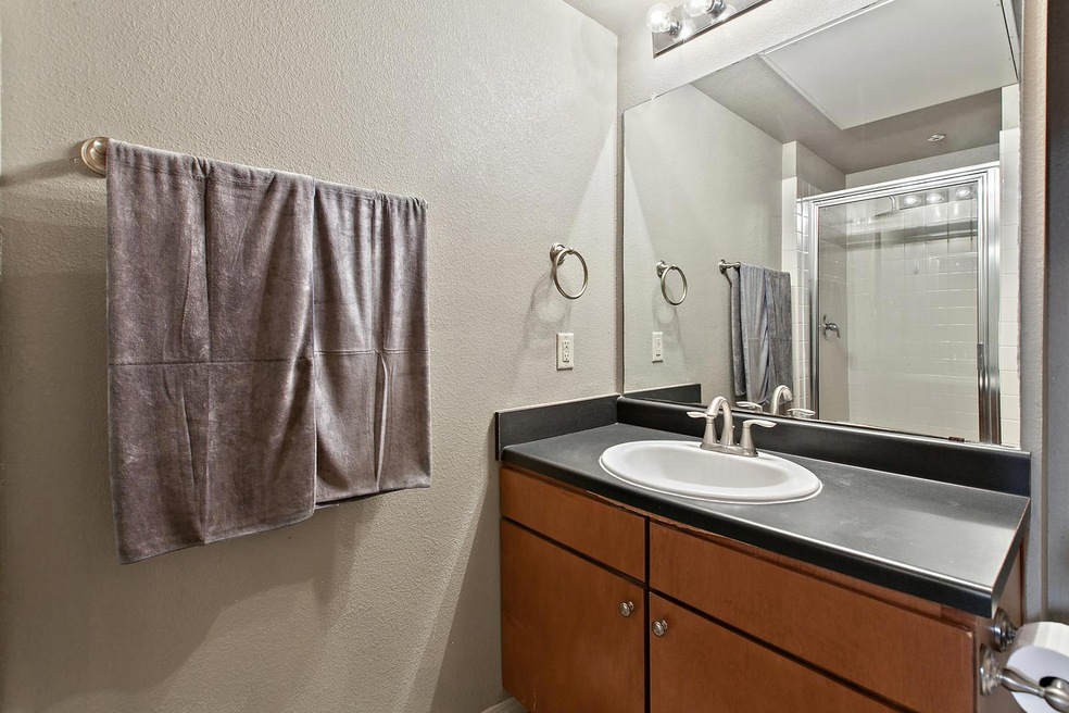 Full bathroom featuring a textured wall, vanity, 