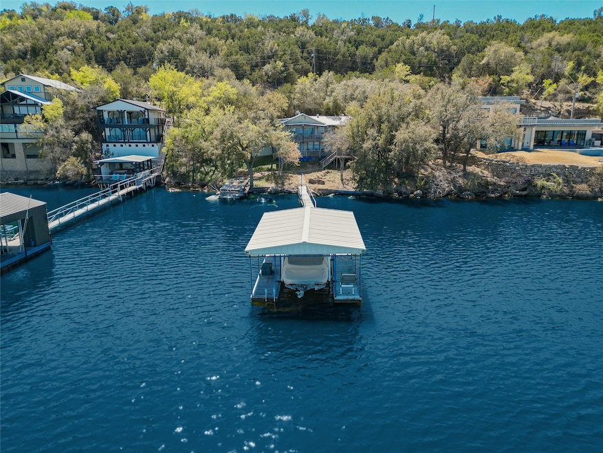 Birds eye view of property with a water view and a