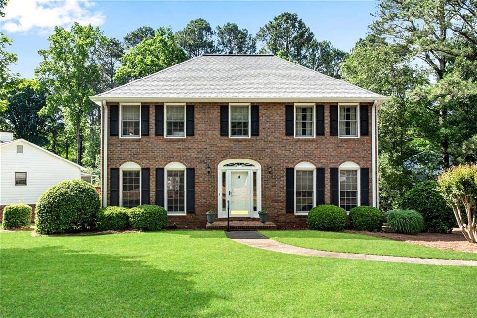 Colonial inspired home featuring a front lawn