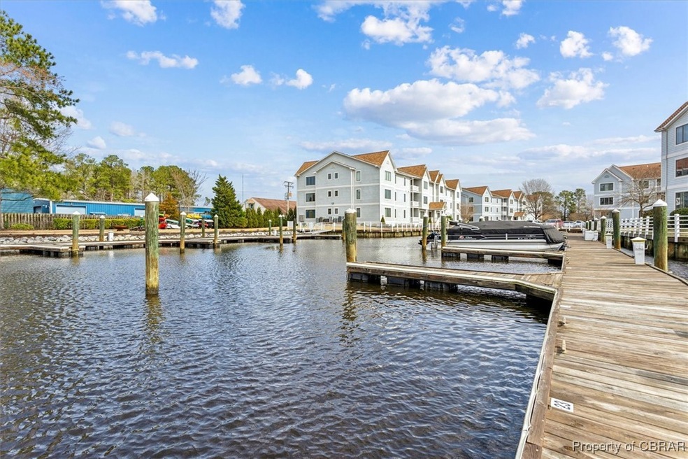 Dock area featuring a residential view and a water