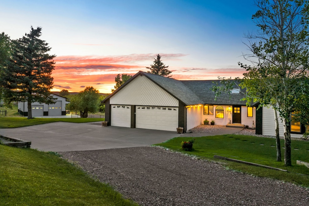 View of front of property with driveway, an attached garage, roof with shingles, and a front lawn