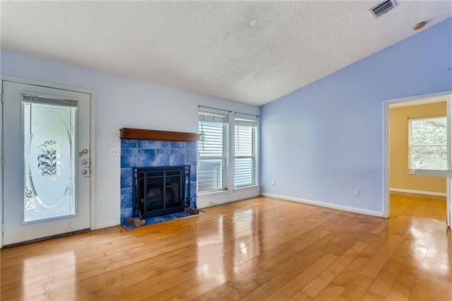 Living boasts vaulted ceiling, wood floors, wood-b