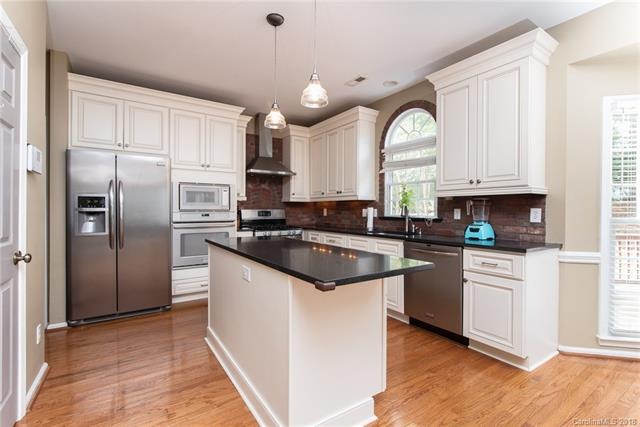 Stunning white kitchen with unique brick backsplas
