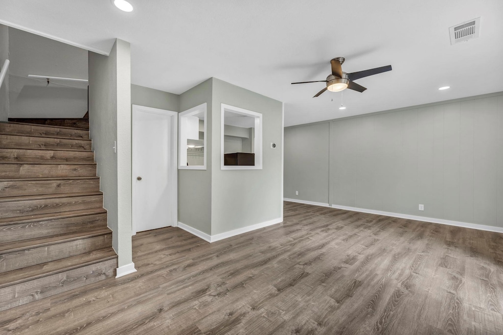 Unfurnished living room with ceiling fan, baseboa