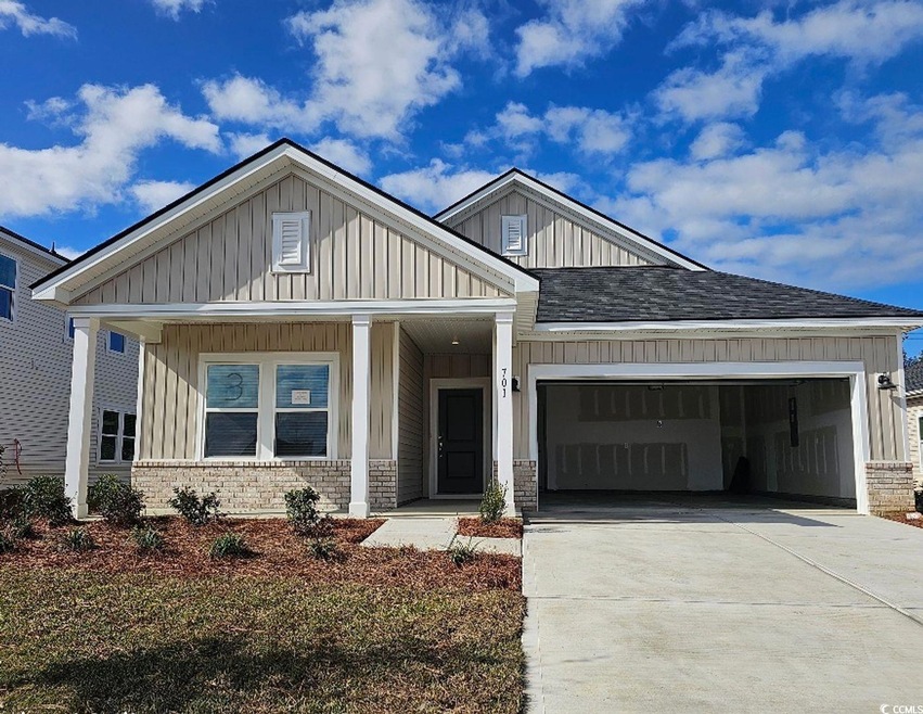 View of front facade with a porch and a garage