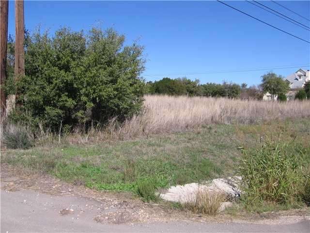 from hwy 290 west road cut looking northeast across lot  to right side (Heritage West Drive)