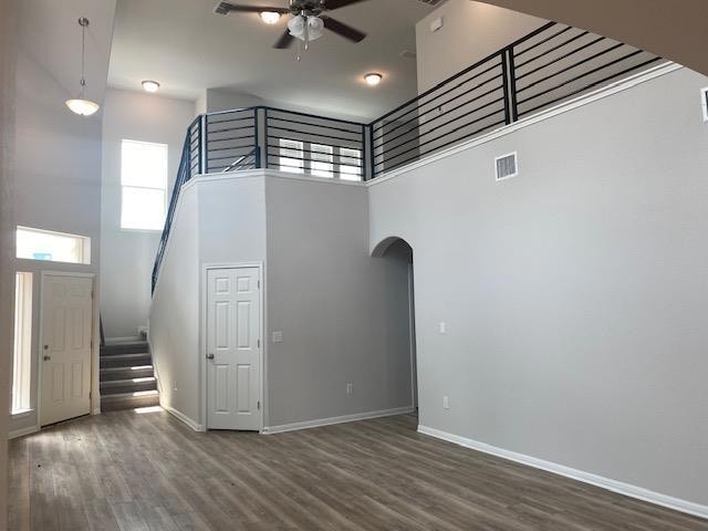 Unfurnished living room featuring a ceiling fan, 