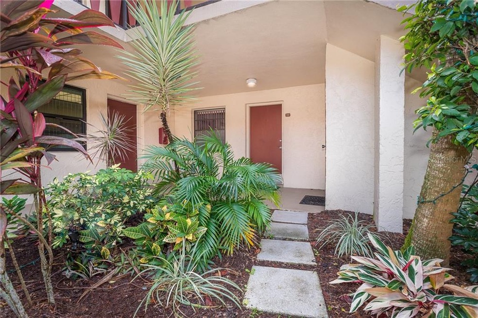Lush tropical landscaping surrounds the complex.